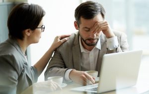 Businesswoman comforting frustrated or tired co-worker